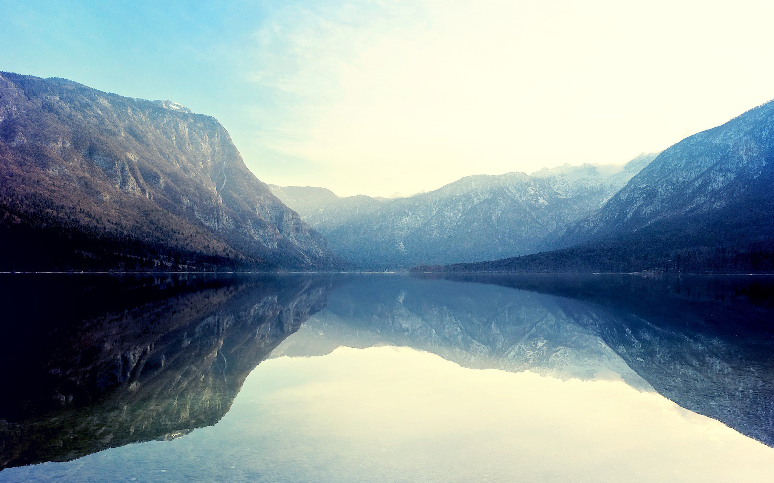 Serene mountain lake reflecting snow-capped peaks in 4K resolution