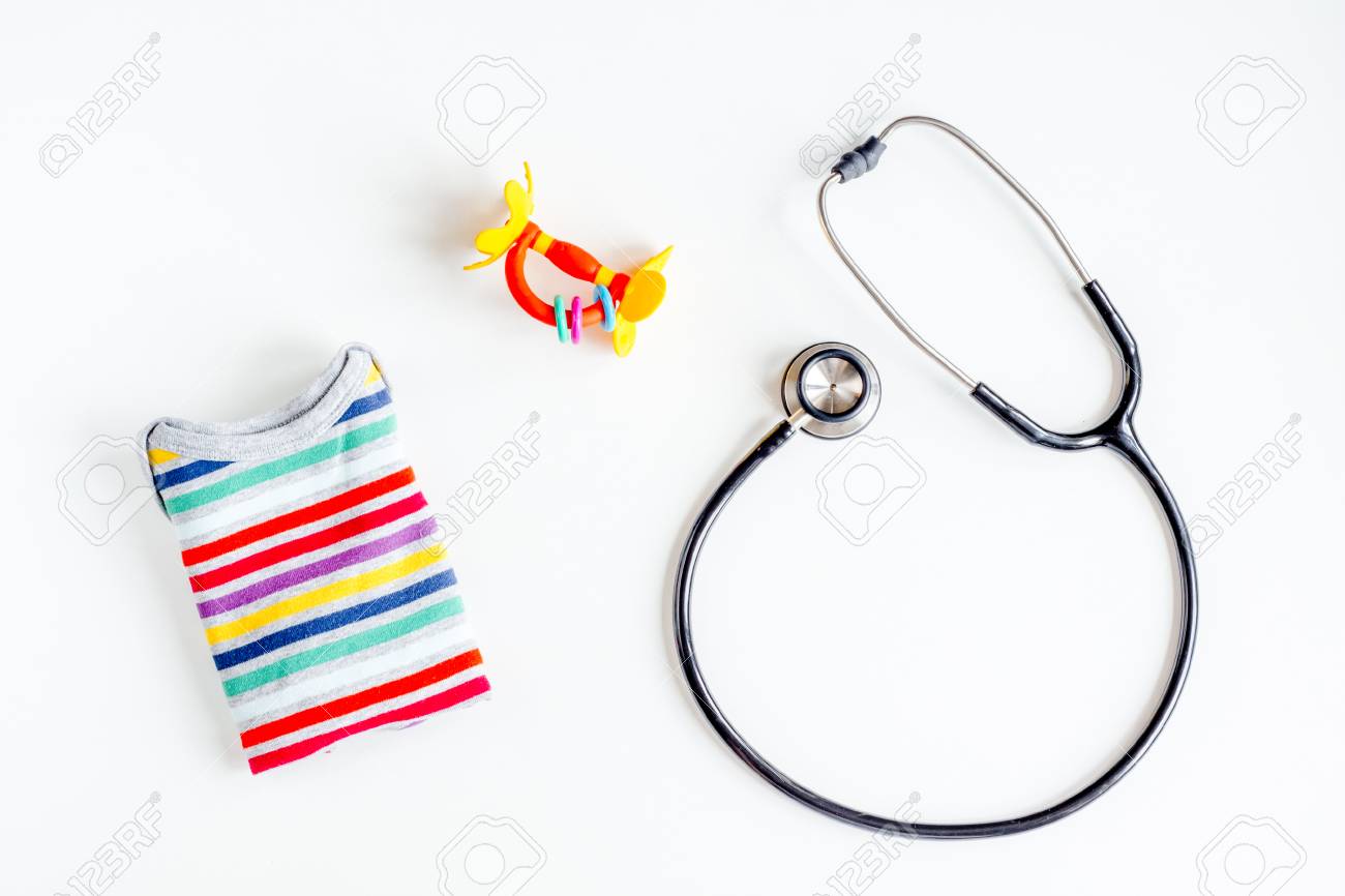 Pediatrician Workplace With Stethoscope And Child Clothes On