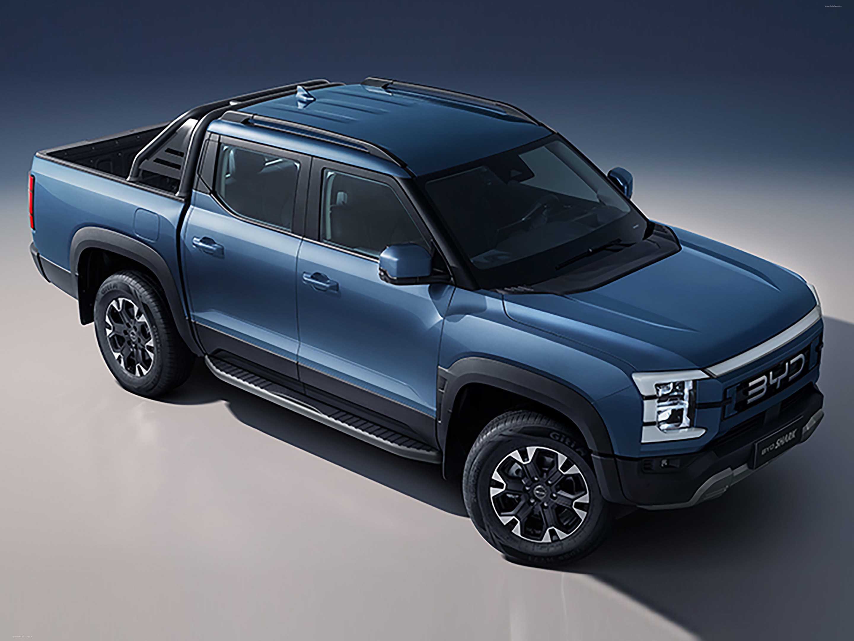 A studio shot of a blue BYD Shanhai pickup truck, highlighting its modern design and rugged features