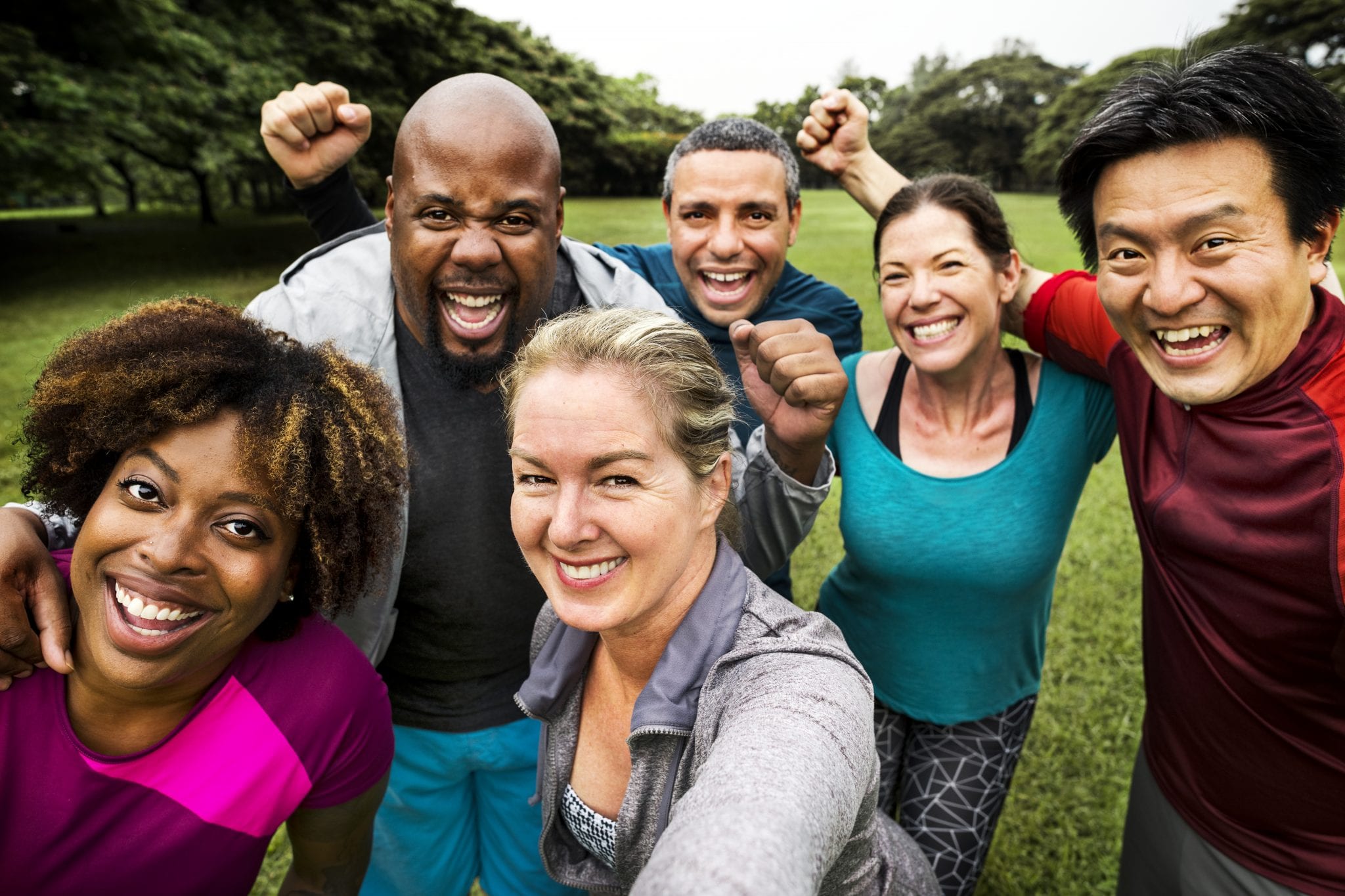 Group Of Cheerful Diverse Friends In The Park Wallpaper