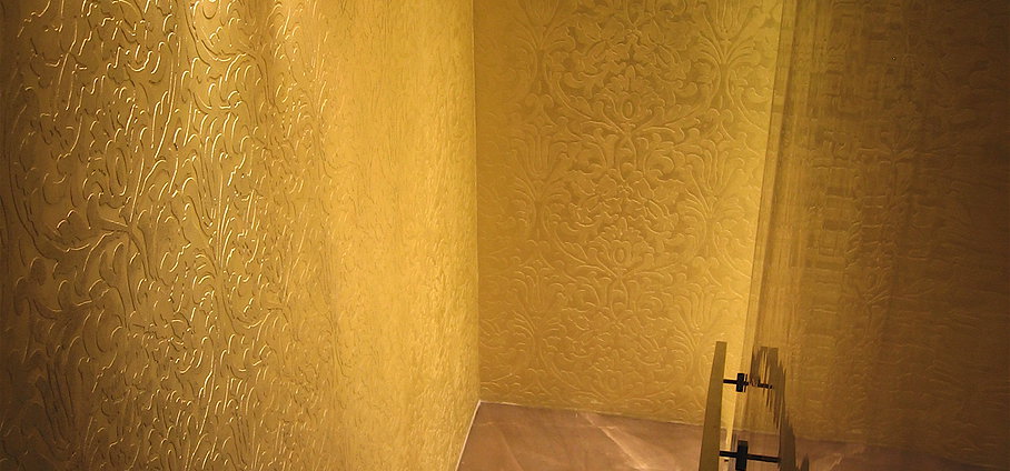 Metallic plaster over paintable wallpaper and venetian stucco