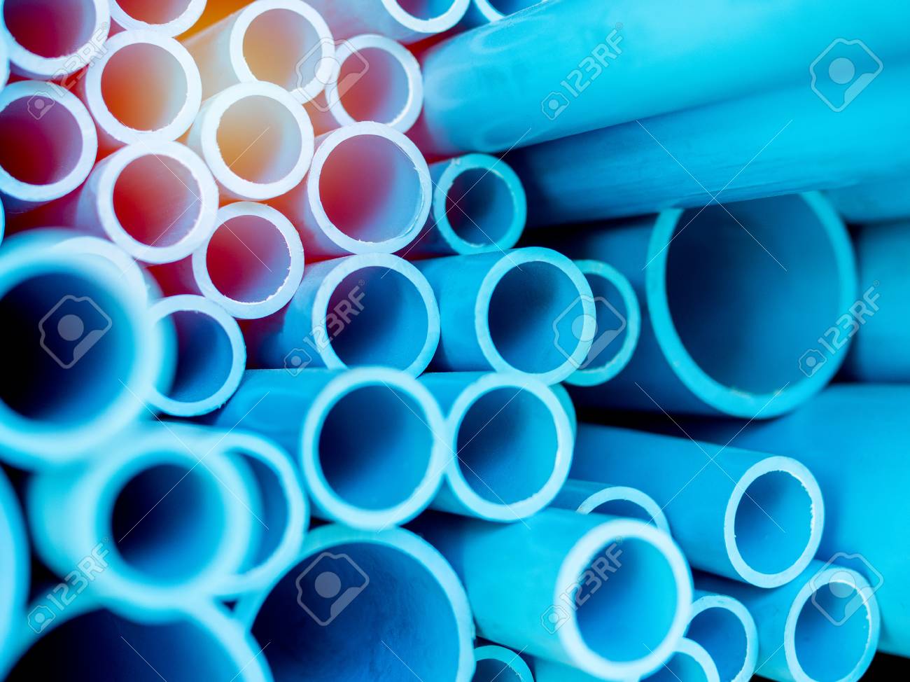 Tubes Pvc Pipes Stacked In Warehouse Blue Background