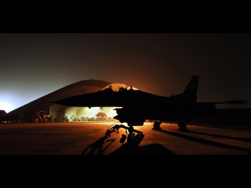 An F 16 fighter on the ground at night