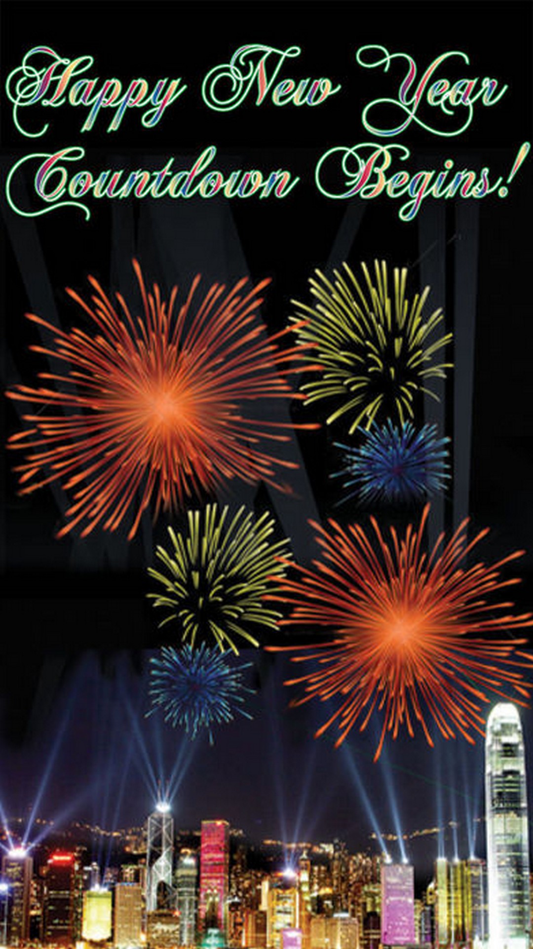 Fireworks explode over a cityscape at night, celebrating New Year's Eve