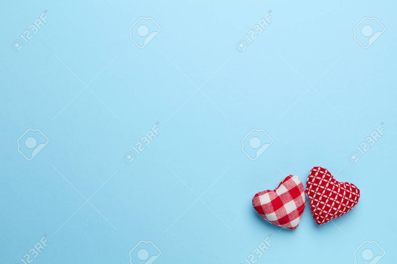 Plain Blue Background With Two Little Red Heart Stock Photo