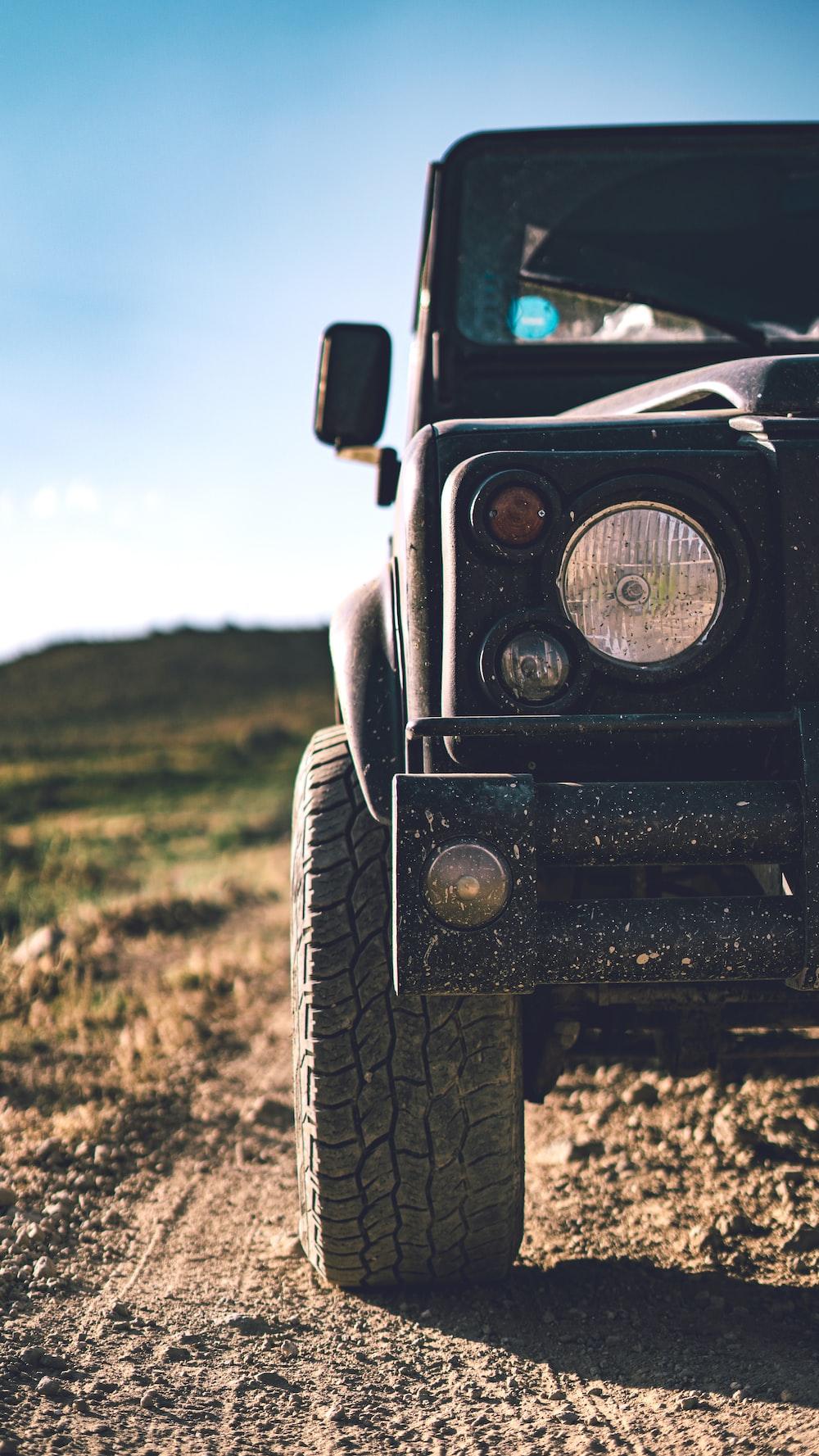 Black Jeep Wrangler On Green Grass Field During Daytime Photo