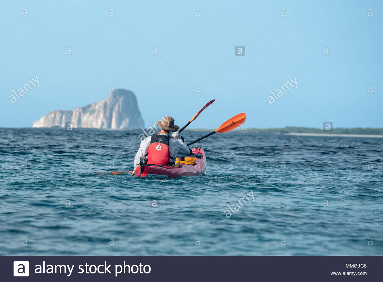 Sea Kayaking Off San Cristobal Island With Kicker Rock In The
