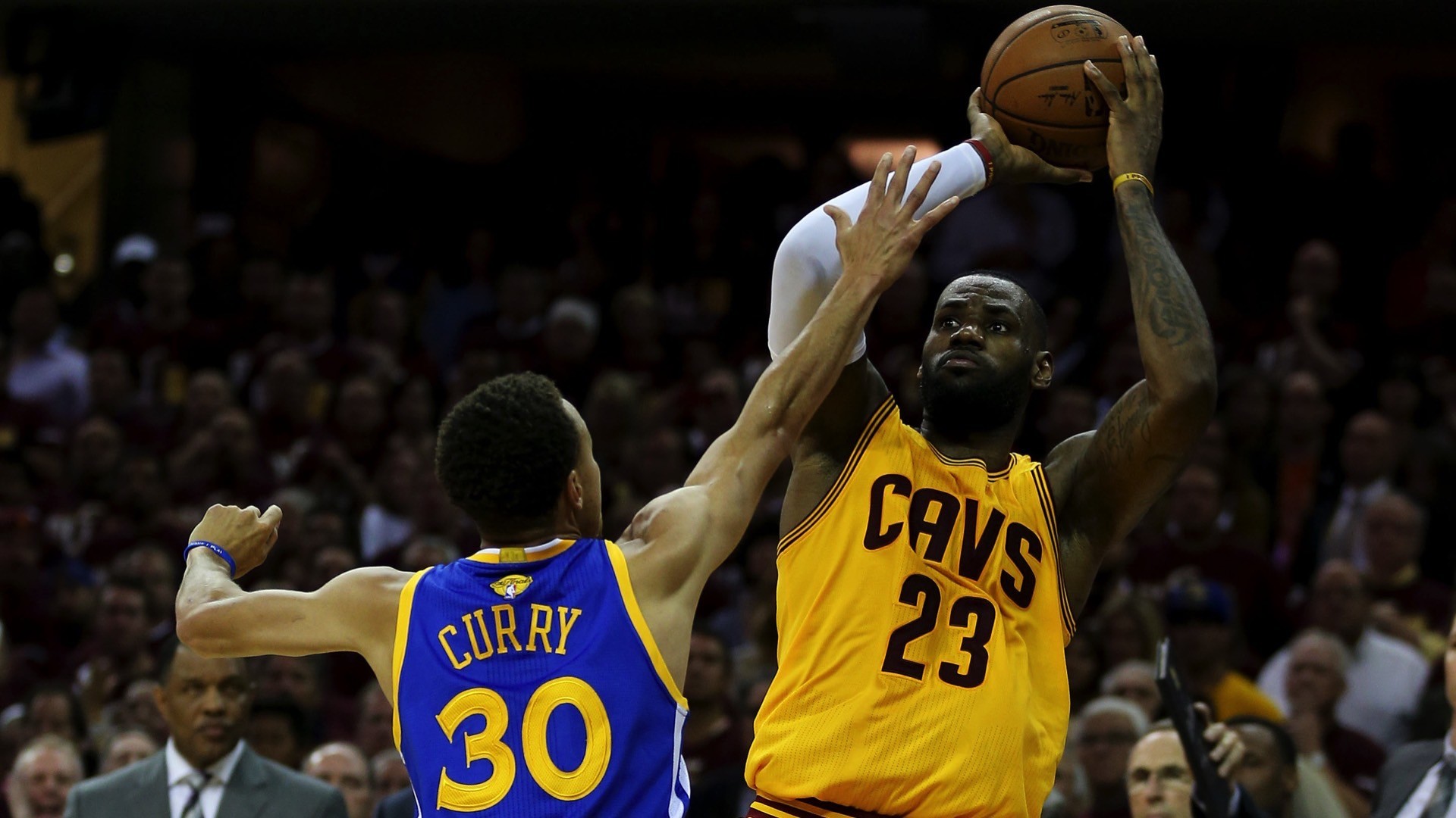 LeBron James shoots the ball over Stephen Curry during an NBA game