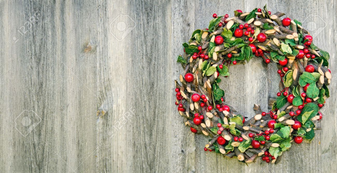 Rustic Christmas Wreath Hanging On A Wooden Vintage Background