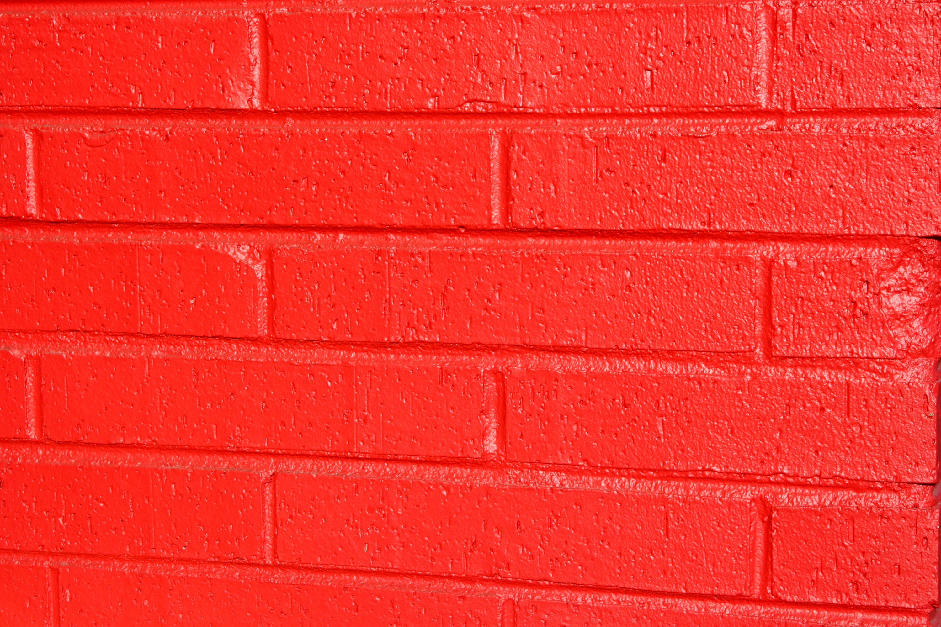 Features A Close Up Of Brick Wall That Has Been Painted Bright Red