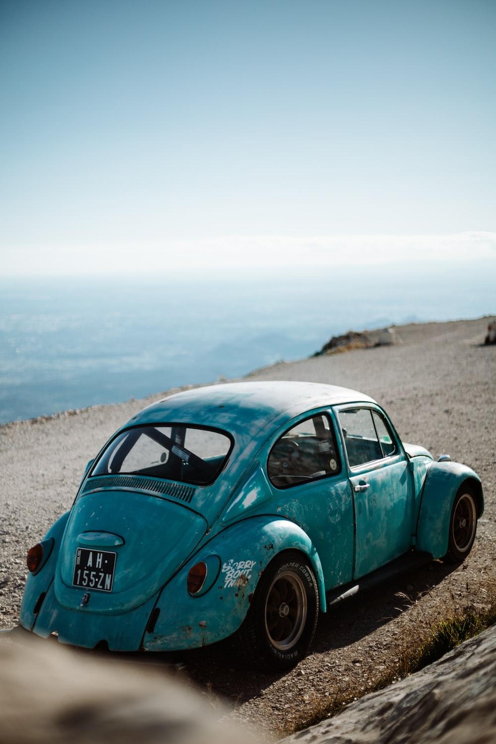 Green Volkswagen Beetle On Brown Sand During Daytime Photo