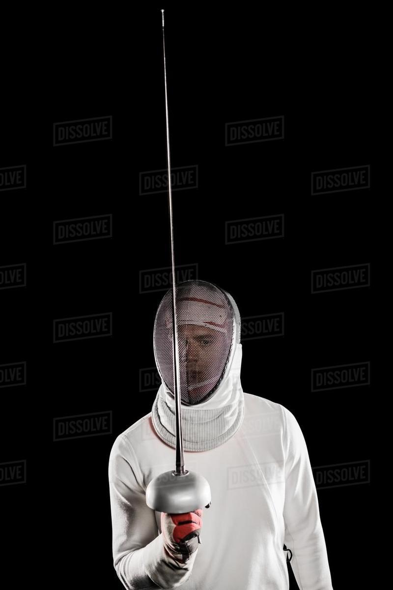 Man Wearing Fencing Suit Practicing With Sword On Black Background