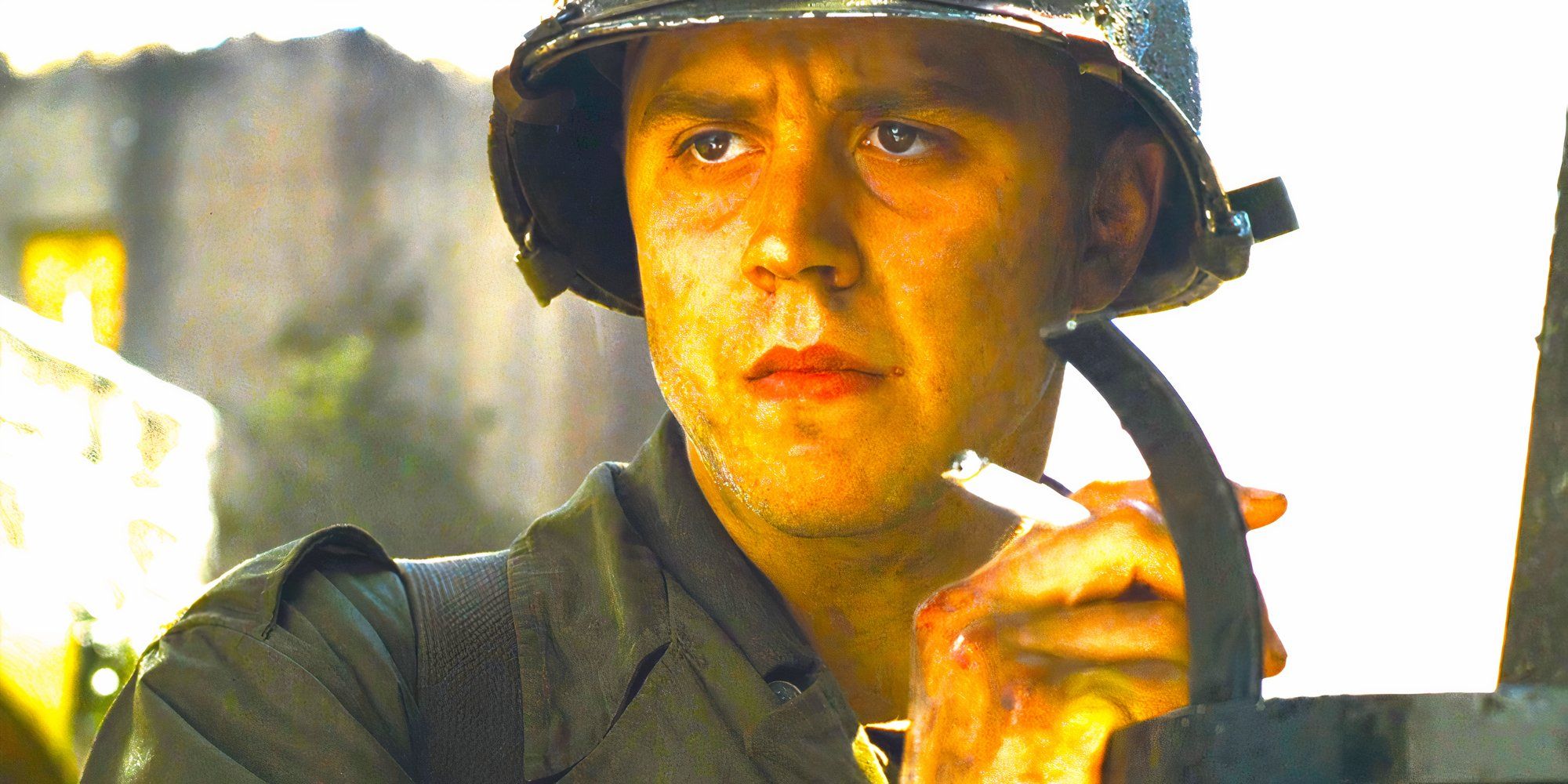 A soldier in a helmet, possibly from a war film, looking intently at something in his hand.  This does not appear to be from Nosferatu