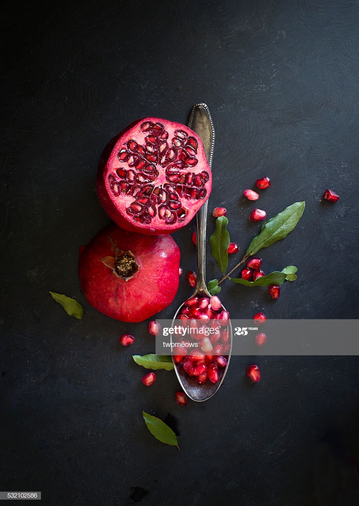 Pomegranate On Black Textured Background High Res Stock Photo