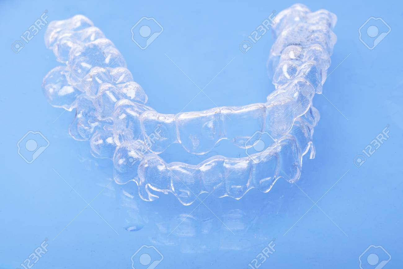 Invisible Dental Teeth Brackets Tooth Aligners On Blue Background