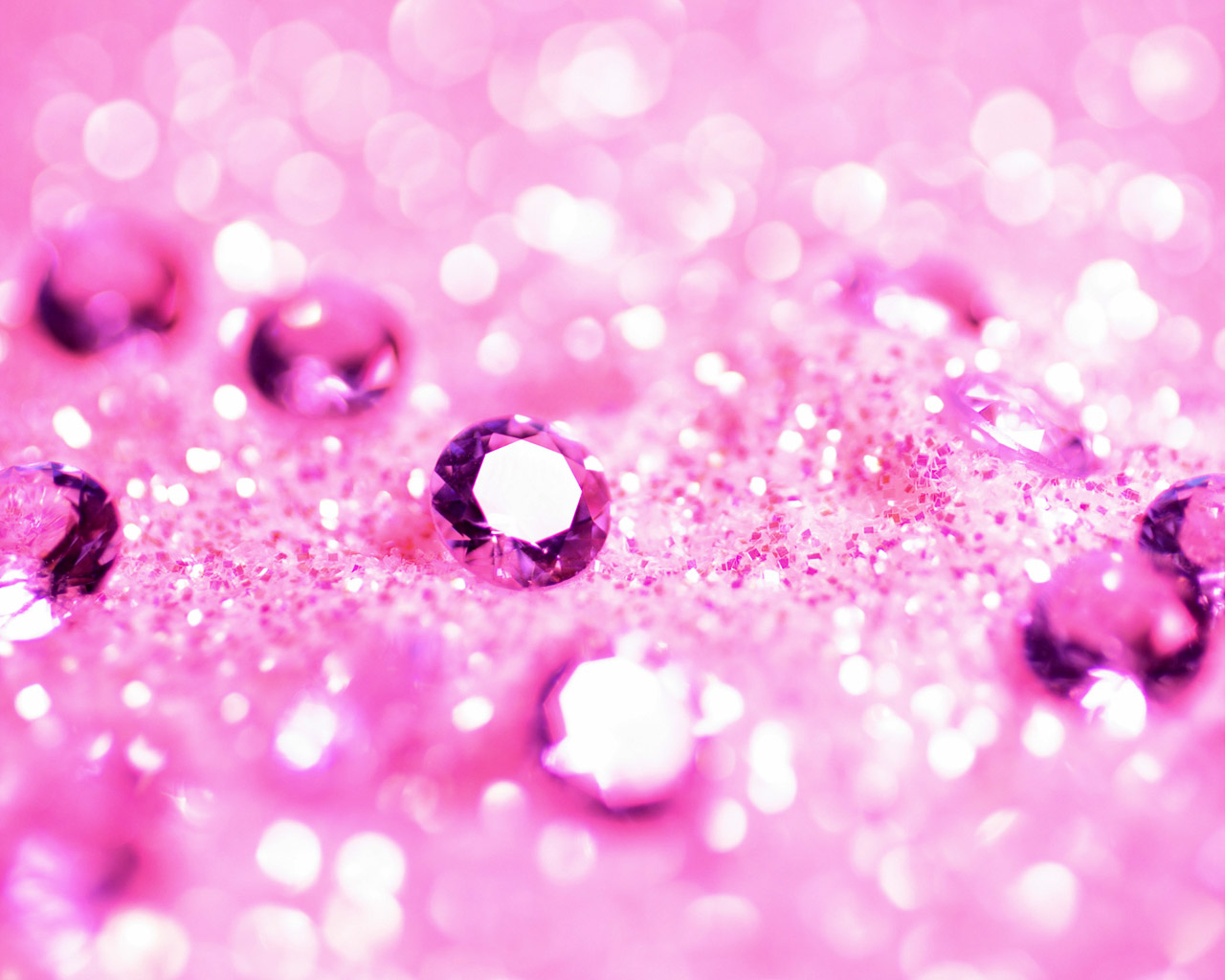 Sparkling pink gemstones on a glittery background