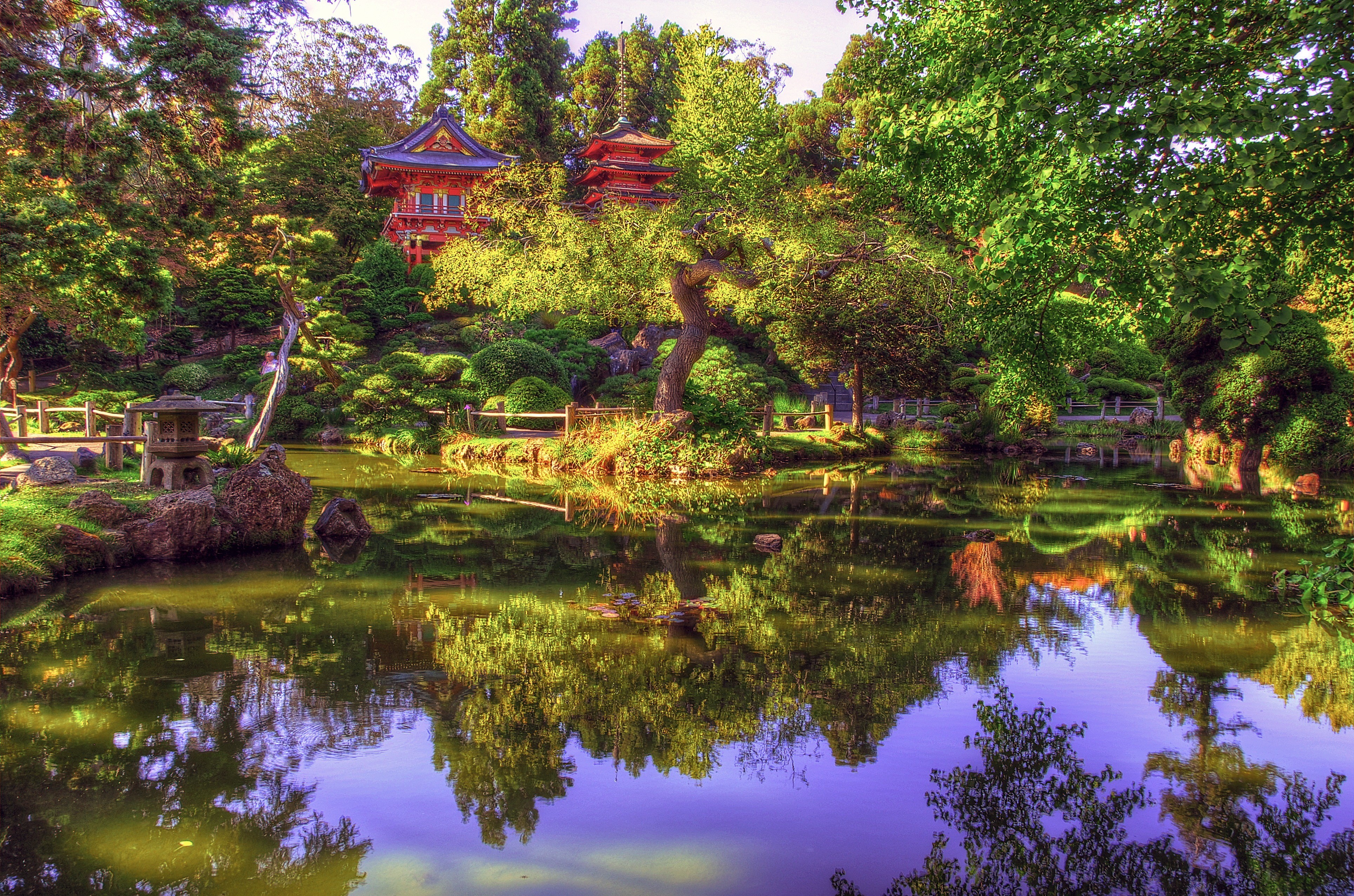 Serene Japanese Garden in 4K: Tranquil pond reflects vibrant trees and traditional pagoda