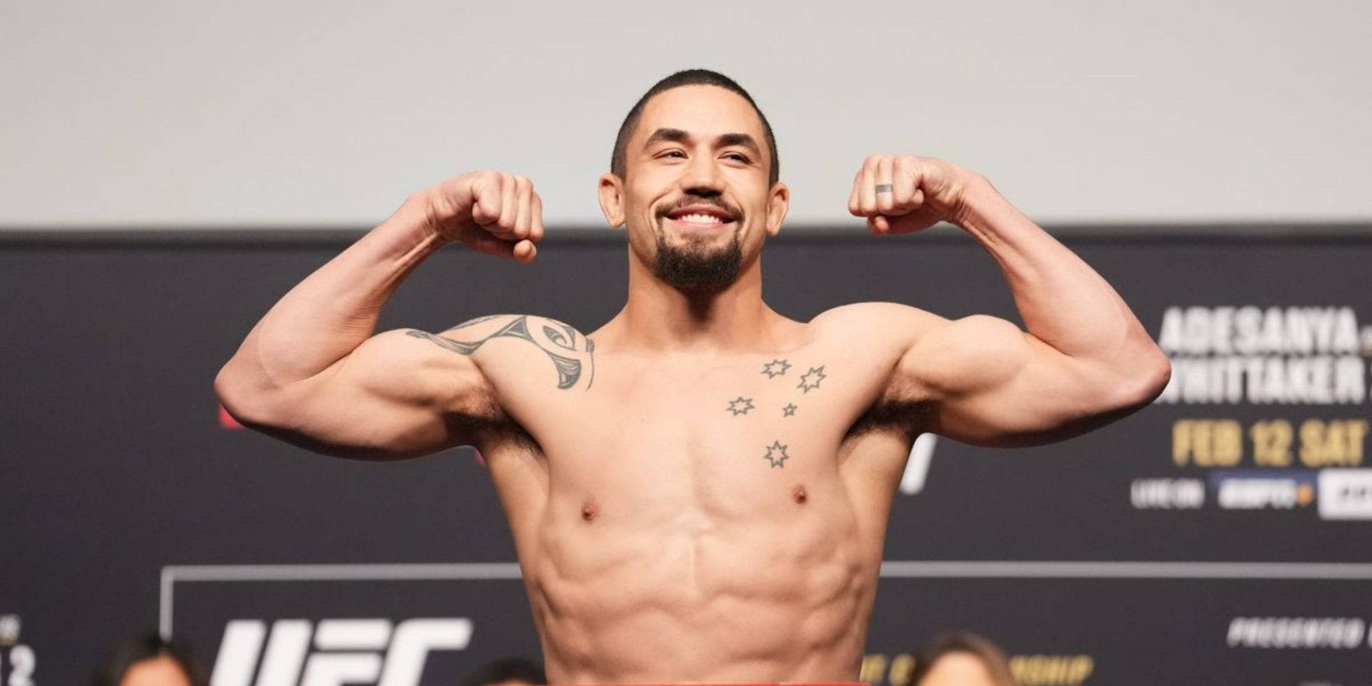 Benjamin Whittaker flexing his biceps at a UFC weigh-in event