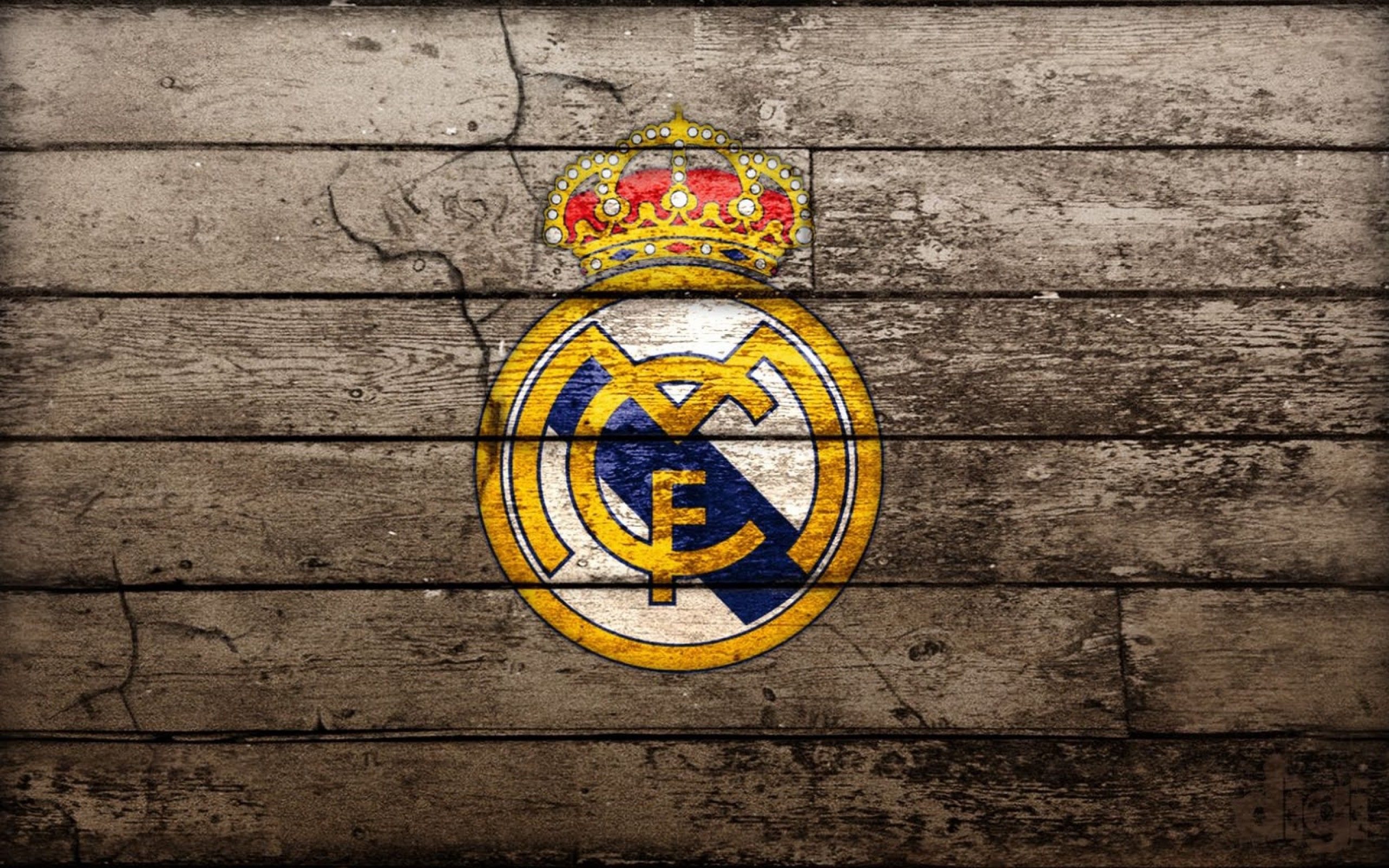 Real Madrid CF logo on rustic wooden background