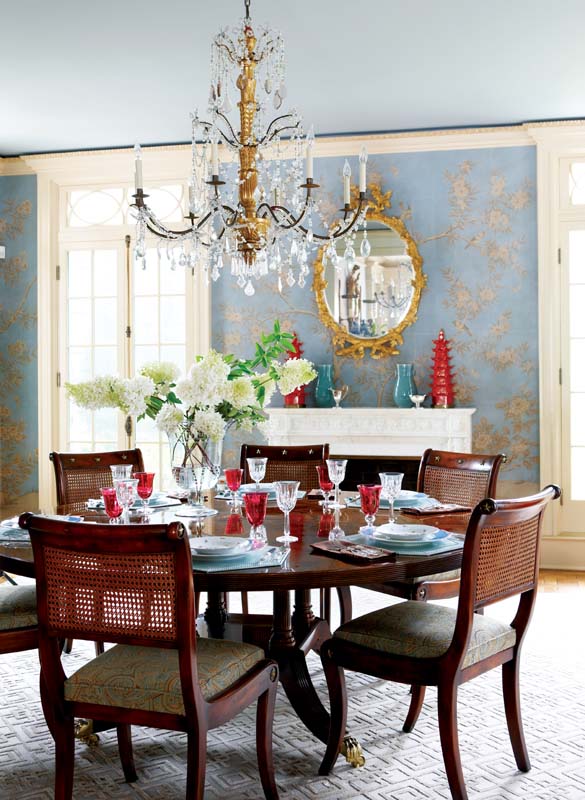 In the dining room Gracie wallpaper a Greek key rug and a pair of