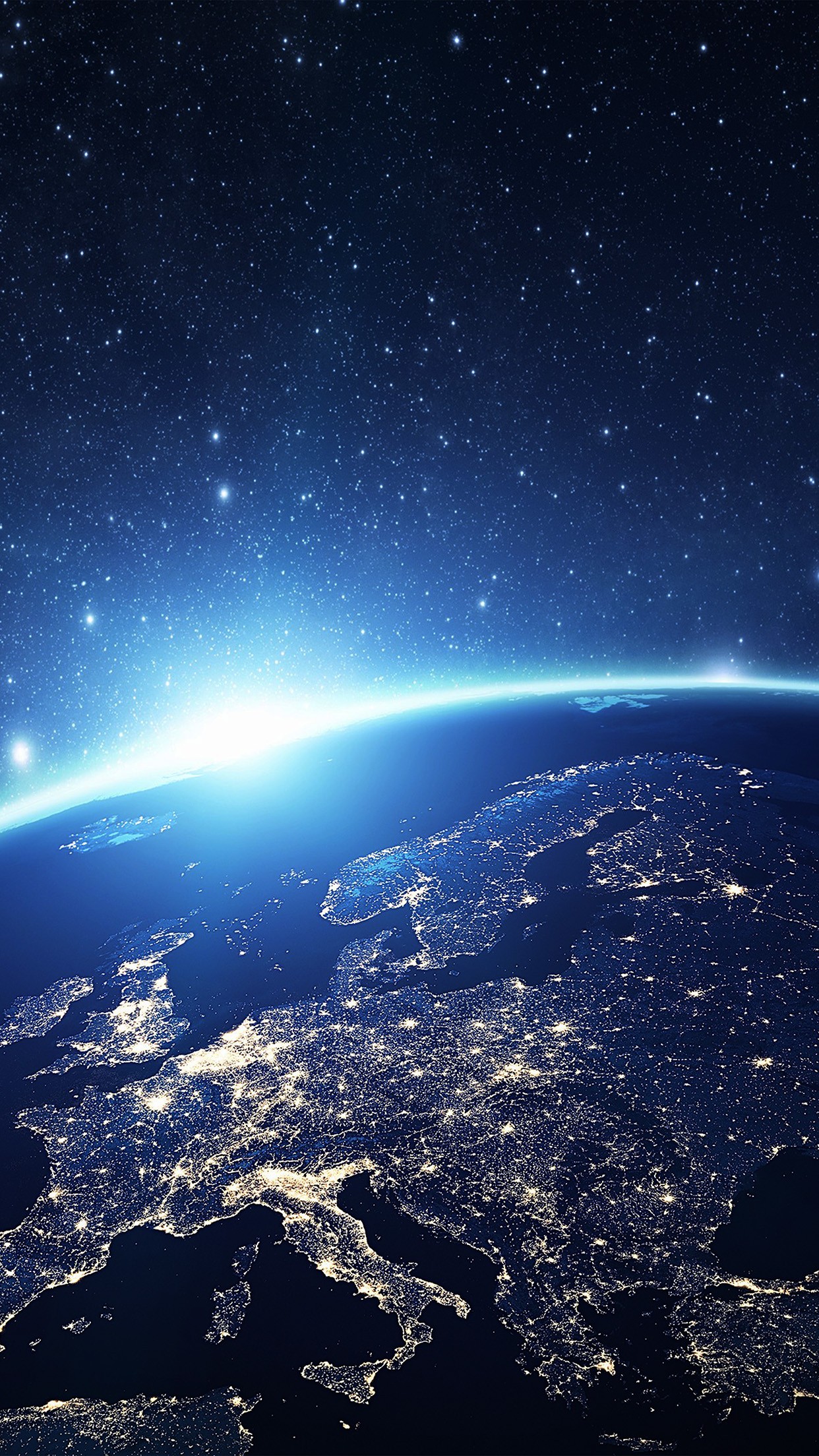 View of Earth from space at night, showing city lights across Europe