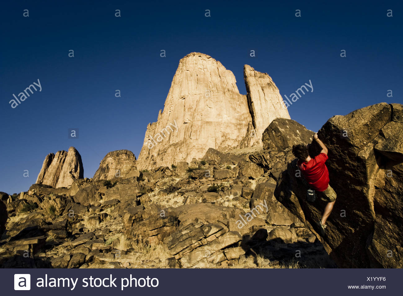 Young Man Bouldering Hand Of Fatima Under Blue Sky In The