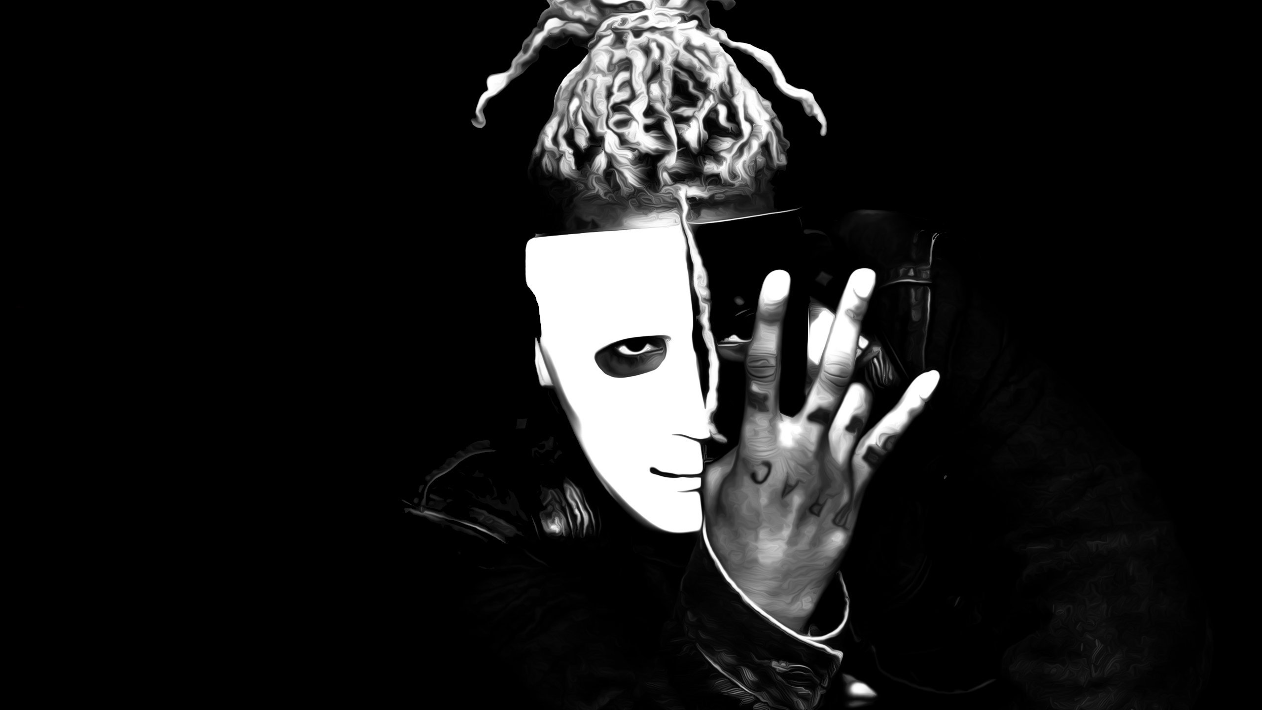 Black and white portrait of XXXTentacion wearing a half-mask and making a hand gesture