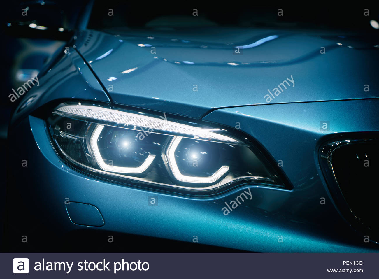 Car Headlight And Hood Of Powerful Sports Blue With Glare