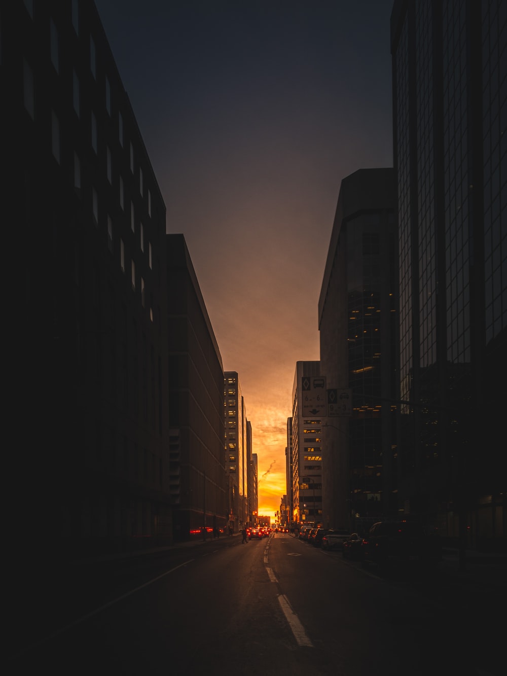 Photography Of Road Between High Rise Building During Sunrise
