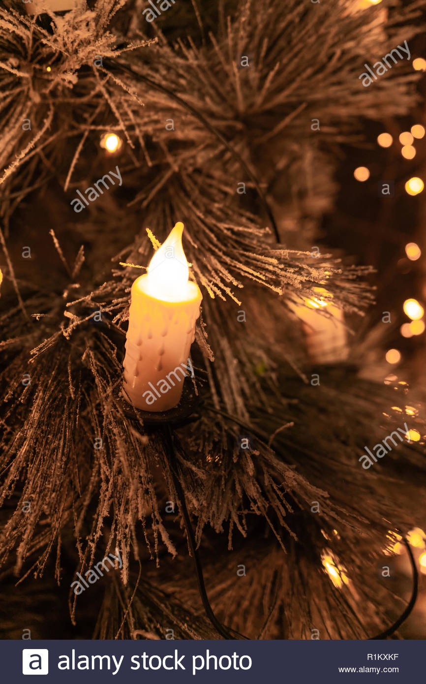 Traditional Candles On Flocked Christmas Tree With Glowing Lights