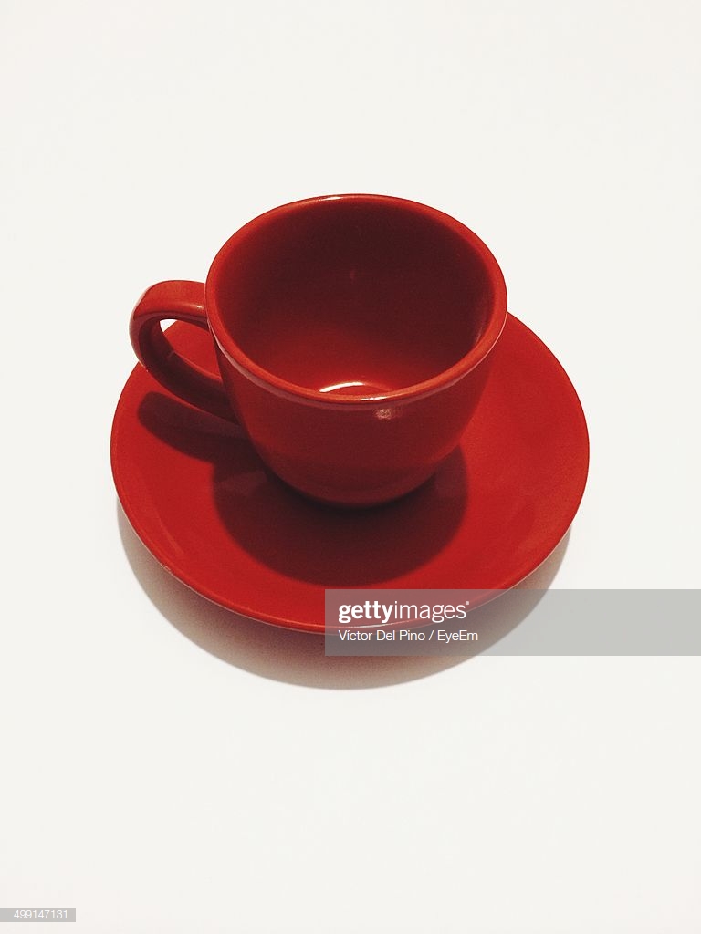 Red Tea Cup And Saucer Against White Background Stock Photo
