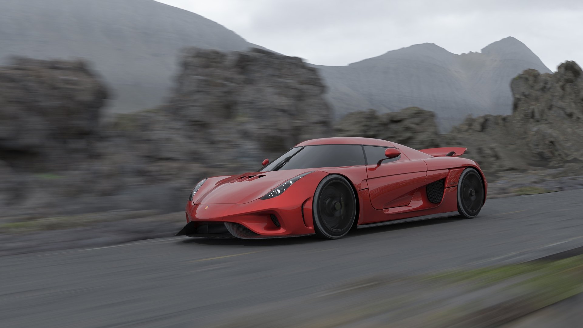 Red sports car driving on a winding road with mountains in the background