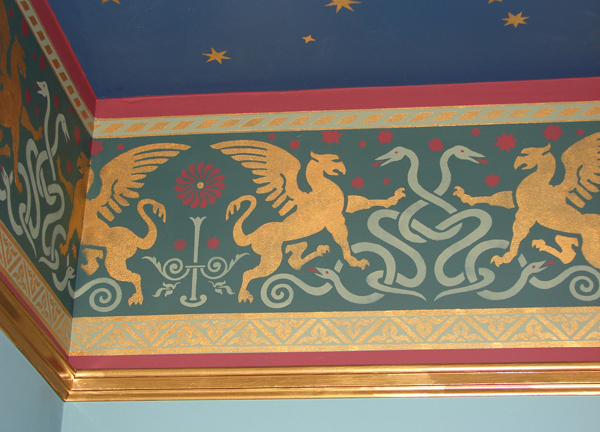 Griffins and snakes prance in the painted frieze Griffin stencil by
