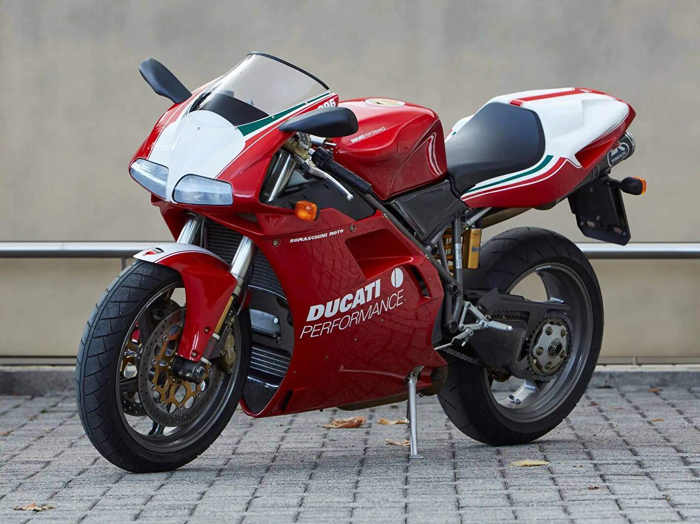 Red and White Ducati 996 Motorcycle Parked on Brick Pavement