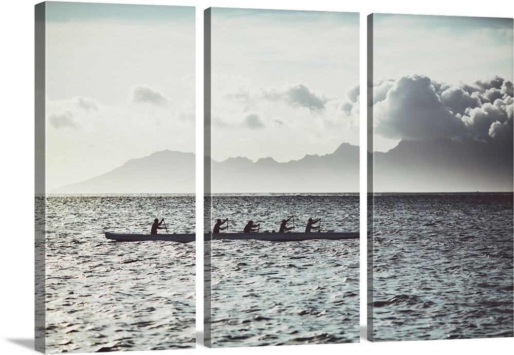 Men Paddle An Outrigger Canoe Off Tahiti Island With Moorea