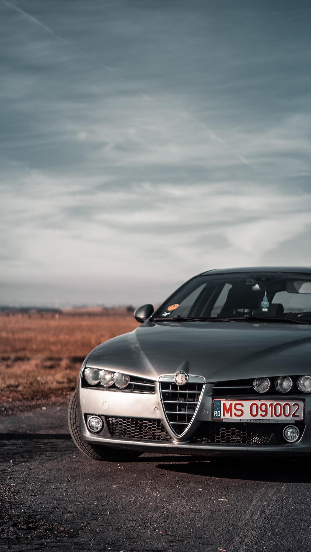 A car parked on the side of the road photo Free Alfa romeo
