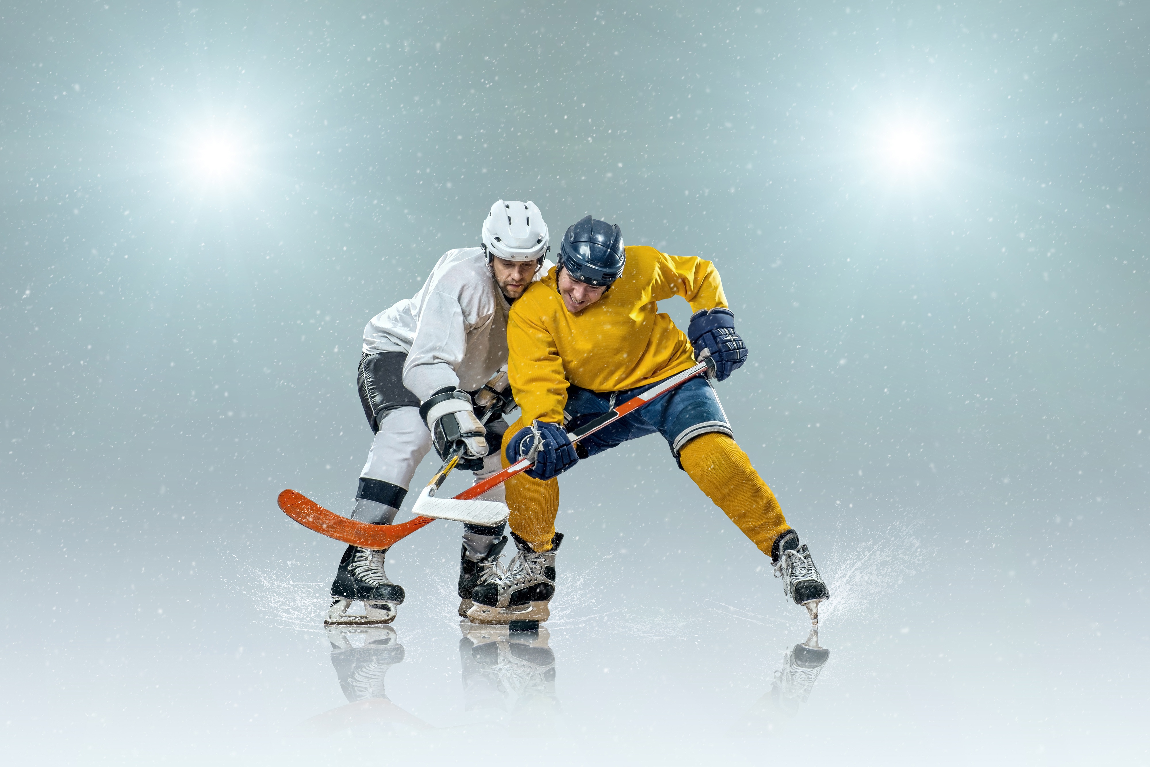 Two ice hockey players competing for the puck during an action-packed game, with dynamic motion and spray from the ice