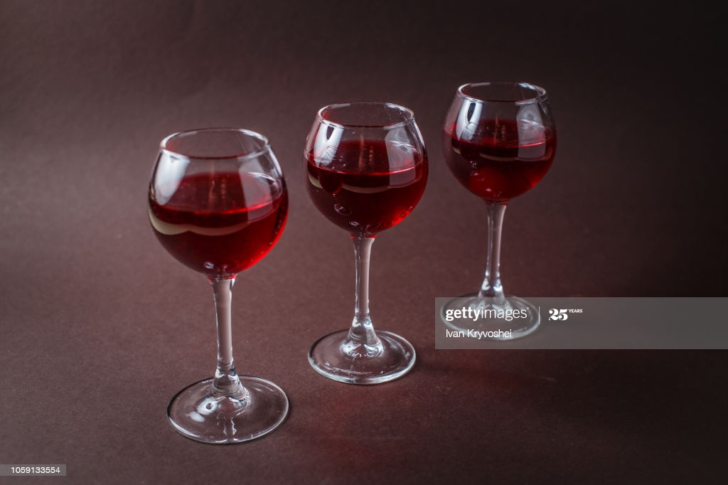 Small Glasses Of Red Liquor On Elegant Dark Brown Background