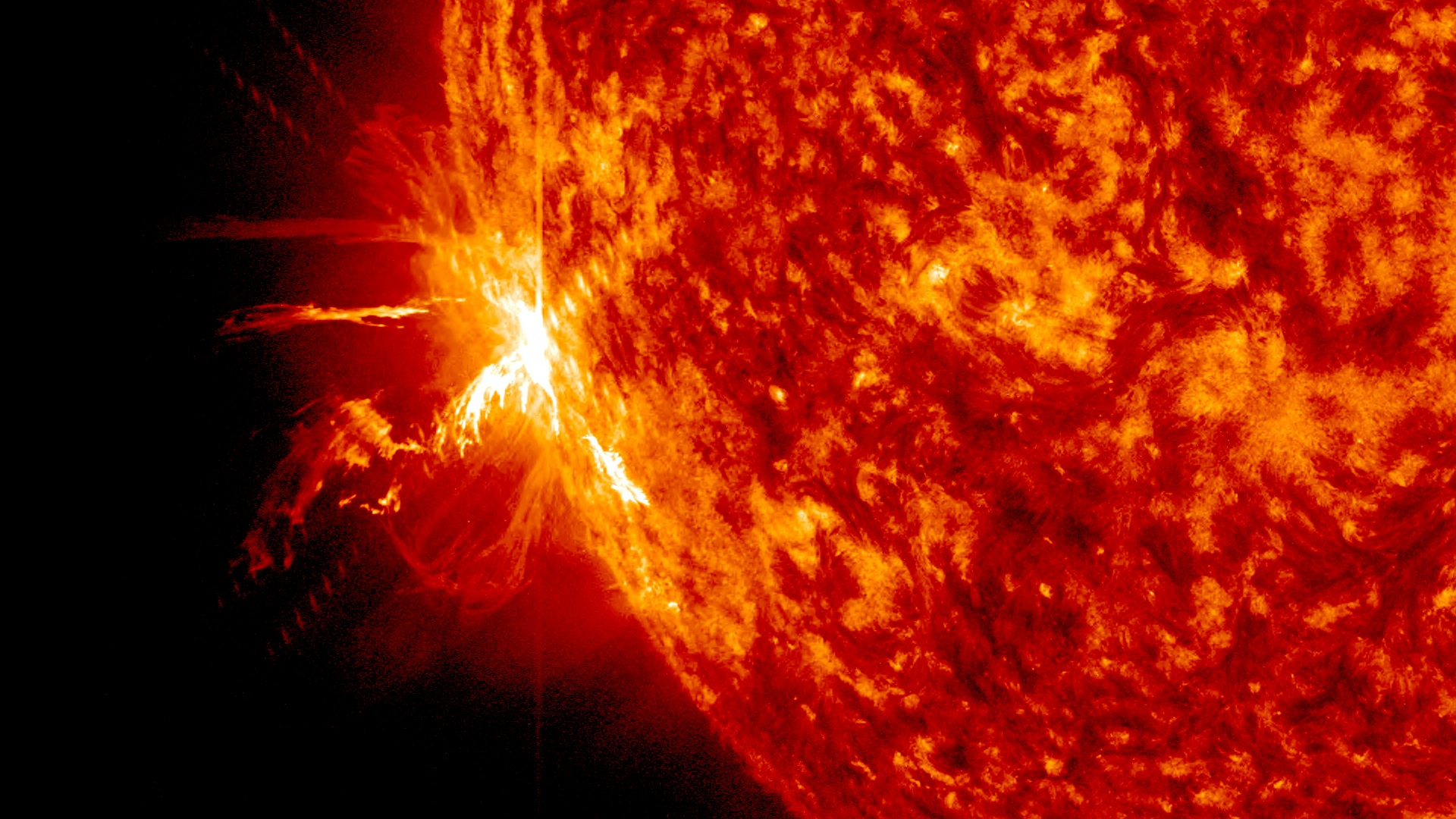 Close-up of a powerful solar flare erupting from the Sun's surface, displaying intense heat and energy
