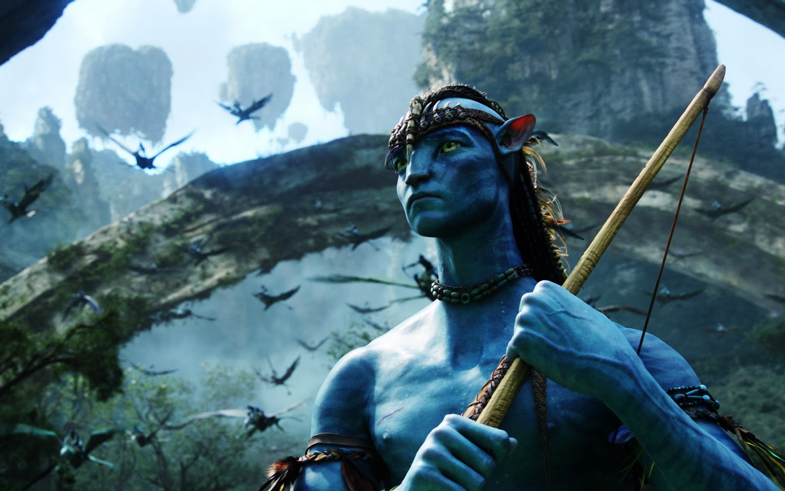 A Na'vi hunter from the movie Avatar stands with a bow and arrow, with the iconic floating Hallelujah Mountains in the background