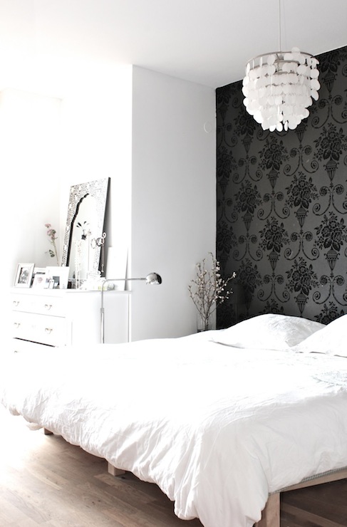Beautiful Bedroom With White Capiz Chandelier Over Platform Bed