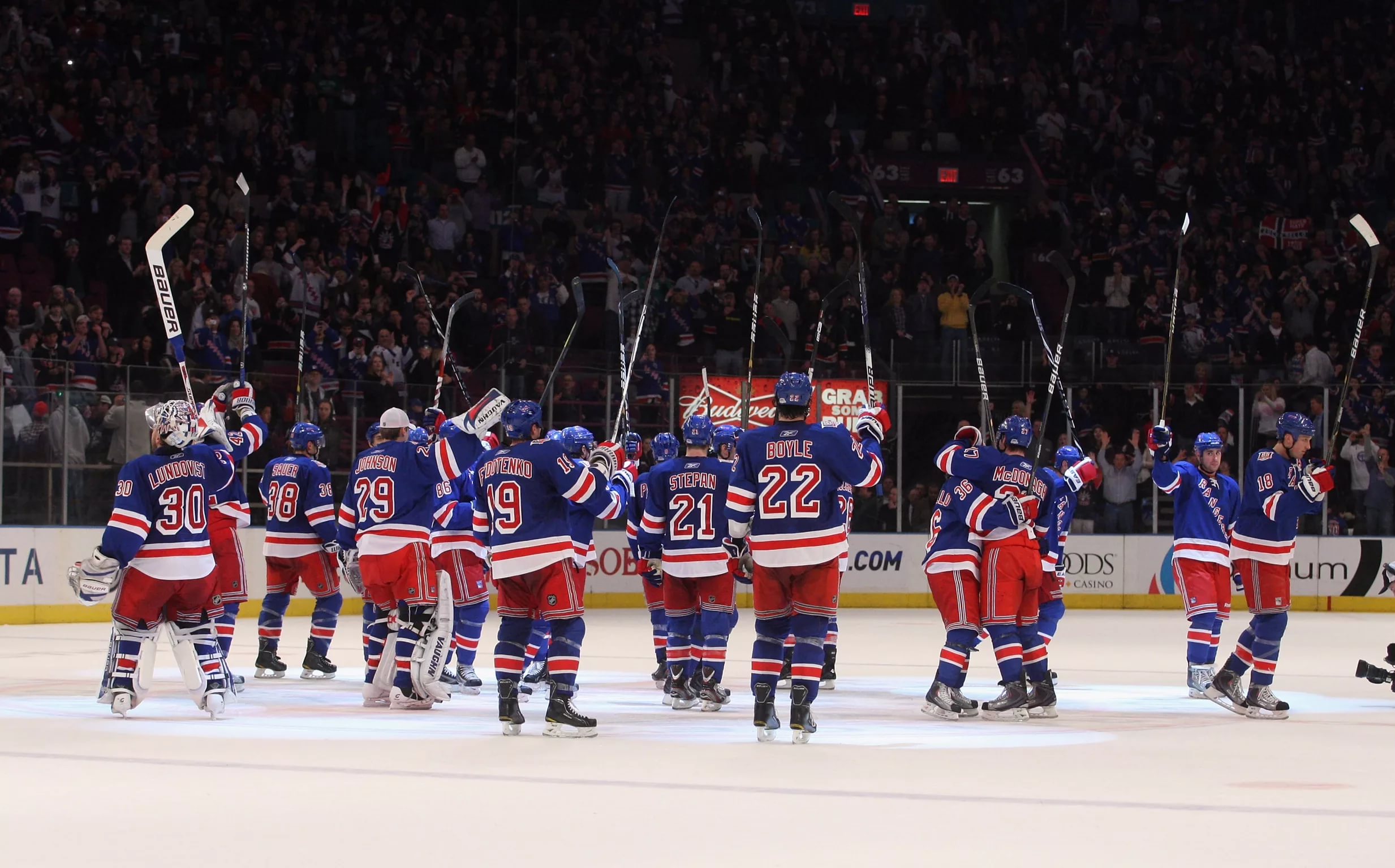 New York Rangers players celebrating a victory on the ice