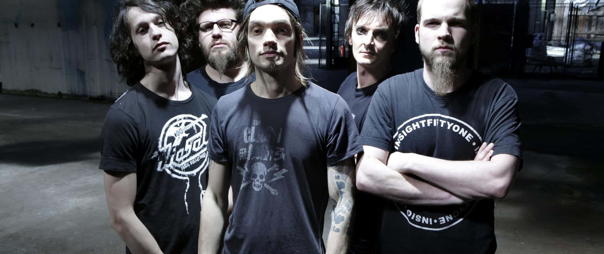 A band poses for a photo in a dimly lit setting