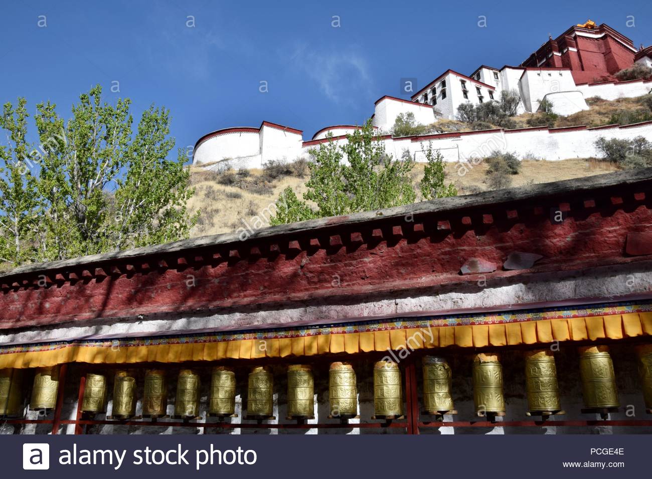 Tibetan Prayer Wheels With Potala Palace In The Background Tibet