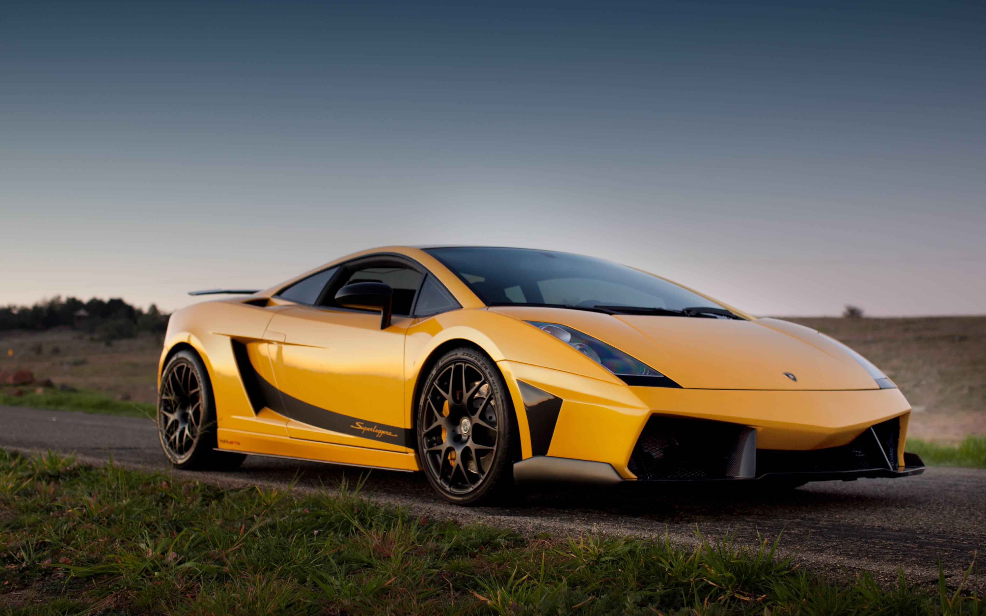 A vibrant yellow Lamborghini Gallardo LP570-4 Superleggera parked on a rural road