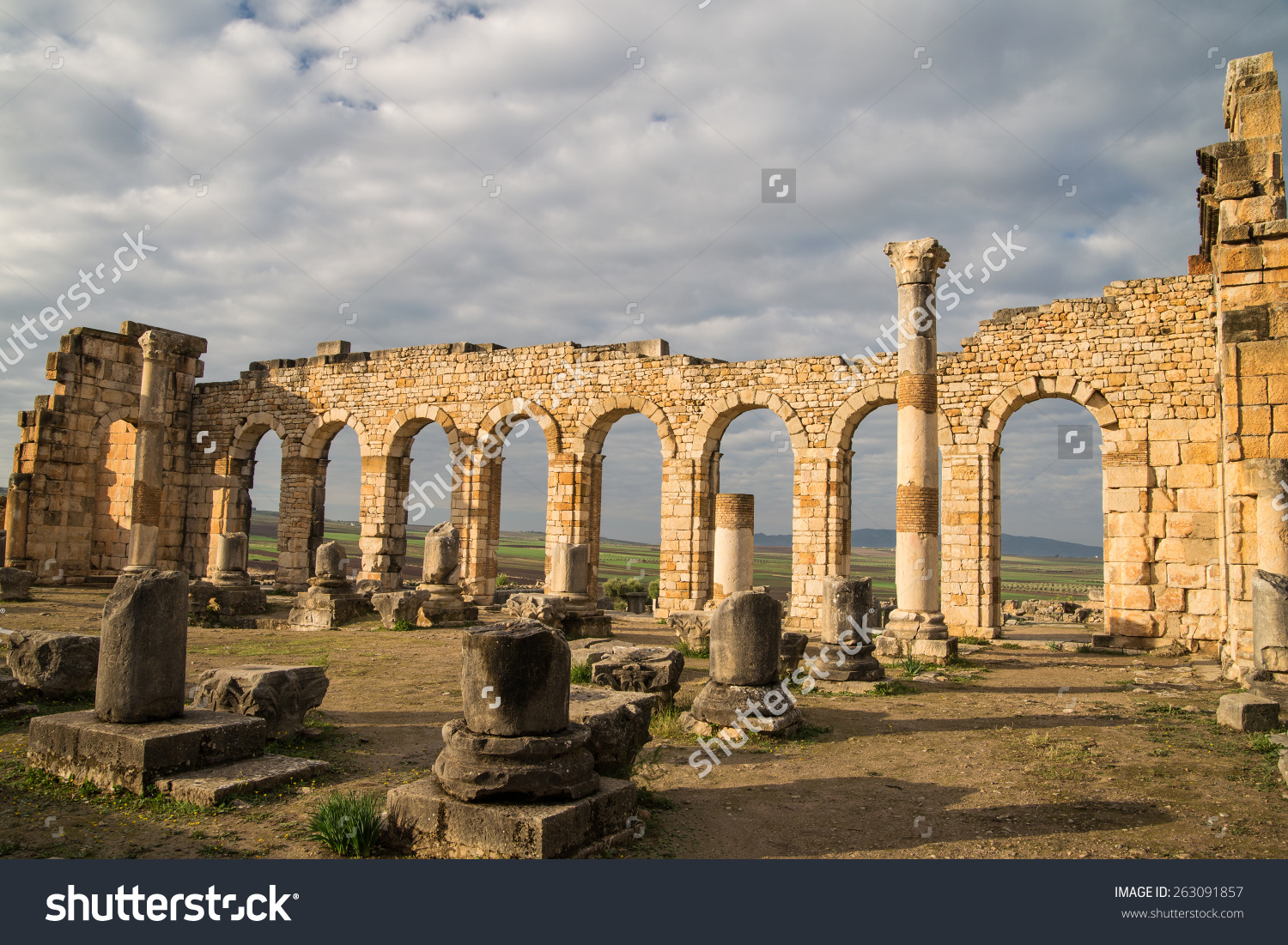 Ancient roman ruins in Morocco with white clouds and blue sky in the