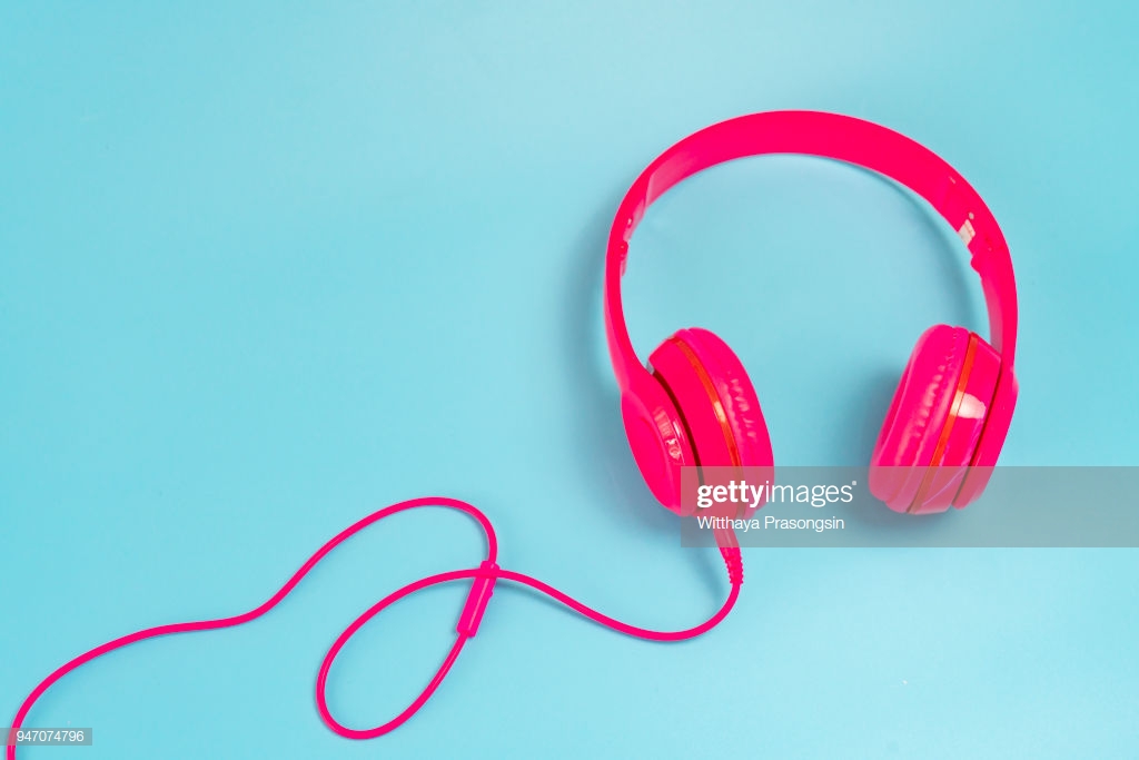Pink Headphone Isolate On Blue Background High Res Stock Photo