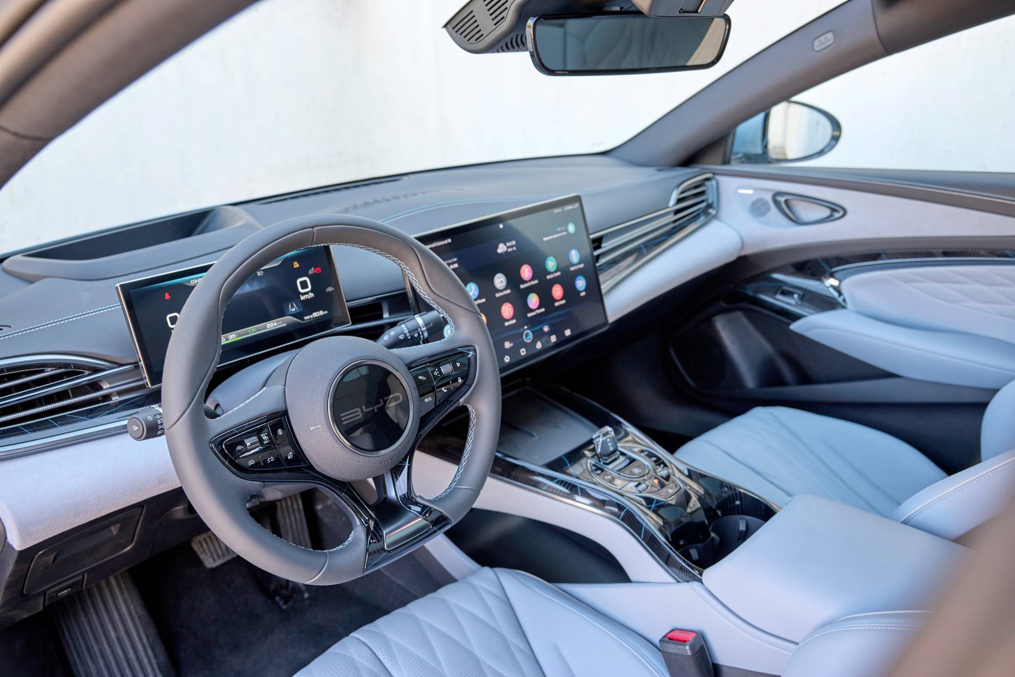 Interior view of a BYD Seal electric car, showcasing its modern dashboard, steering wheel, and infotainment system