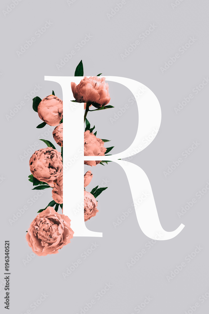 A monogram of the letter R decorated with pink peonies and