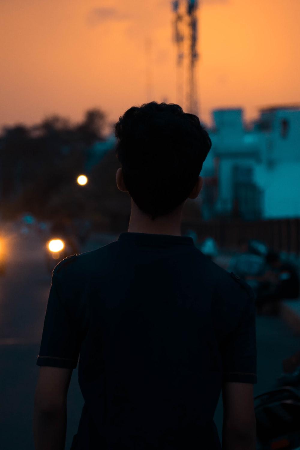 Shallow Focus Photo Of Person In Black Polo Shirt
